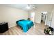 Bedroom with hardwood floors, ceiling fan, and a walk-in closet at 6446 Louisiana Ave, New Port Richey, FL 34653