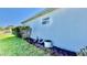 Exterior shot showing well maintained lawn, landscaping, and house utility connections at 6446 Louisiana Ave, New Port Richey, FL 34653