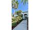 Inviting front yard with tropical landscaping and a walkway leading to the entrance at 6446 Louisiana Ave, New Port Richey, FL 34653