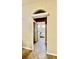 Arched hallway leading to bathroom with tub and shower at 6446 Louisiana Ave, New Port Richey, FL 34653