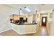 Kitchen featuring a breakfast bar with dark countertops, wood cabinets, and stainless steel appliances at 6446 Louisiana Ave, New Port Richey, FL 34653