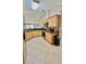 Bright kitchen with wooden cabinets, tile floors, and stainless steel appliances at 6446 Louisiana Ave, New Port Richey, FL 34653