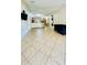 Expansive tiled living area offering abundant natural light and seamless flow to the kitchen at 6446 Louisiana Ave, New Port Richey, FL 34653