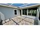 Covered patio with stone tiling and access to sun room at 6446 Louisiana Ave, New Port Richey, FL 34653