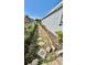 Landscaped side yard with stone paver path, rock ground cover, and green shrubs at 6446 Louisiana Ave, New Port Richey, FL 34653