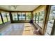 Enclosed sun room with play accessories and ceiling fan at 6446 Louisiana Ave, New Port Richey, FL 34653