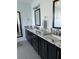 Bathroom featuring double sinks, elegant granite countertops, and modern fixtures at 7033 123Rd St, Seminole, FL 33772