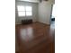 Bedroom with hardwood floors, ample natural light, and a small wooden chest at 7033 123Rd St, Seminole, FL 33772