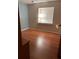 Bedroom features hardwood flooring, a large window, and warm lighting at 7033 123Rd St, Seminole, FL 33772