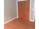 Cozy bedroom featuring hardwood floors and a wooden closet for ample storage at 7033 123Rd St, Seminole, FL 33772