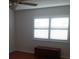 Bedroom features hardwood flooring, window with blinds, and ceiling fan at 7033 123Rd St, Seminole, FL 33772