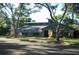 Beautifully landscaped home with a modern roof design and mature trees at 7033 123Rd St, Seminole, FL 33772