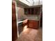 Kitchen featuring stainless steel dishwasher, granite countertops and wooden cabinets on a tiled floor at 7033 123Rd St, Seminole, FL 33772