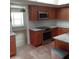 This is a full kitchen with stainless steel appliances, granite countertops, and wood cabinets at 7033 123Rd St, Seminole, FL 33772