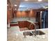 Bright kitchen featuring stainless appliances, granite countertops, and warm wood cabinetry at 7033 123Rd St, Seminole, FL 33772