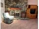 Living room space with a stone fireplace and wood built-ins at 7033 123Rd St, Seminole, FL 33772