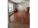Open-concept living room features hardwood floors, bright windows, and neutral walls at 7033 123Rd St, Seminole, FL 33772