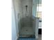 Sleek glass-enclosed shower with contemporary fixtures and stone surround at 7033 123Rd St, Seminole, FL 33772
