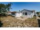 Backyard featuring a detached building and a small patio at 7420 Cay Dr, Port Richey, FL 34668
