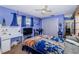 Comfortable bedroom features ceiling fan, desk, and a decorative blanket at 7420 Cay Dr, Port Richey, FL 34668