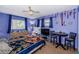 Comfortable bedroom with ceiling fan, desk, and a decorative blanket at 7420 Cay Dr, Port Richey, FL 34668