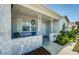 Inviting front porch with seating area, decorative wreath, and classic design at 7420 Cay Dr, Port Richey, FL 34668
