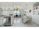 Charming kitchen features stainless steel appliances, breakfast nook, and ceramic tile floors at 7420 Cay Dr, Port Richey, FL 34668