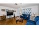 Cozy living room with hardwood floors, comfortable seating, and bright natural lighting at 7420 Cay Dr, Port Richey, FL 34668