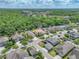 Wide aerial view showing the location of the home in a well-situated neighborhood and lush surrounding forest at 7927 Hampton Lake Dr, Tampa, FL 33647