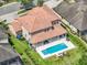Backyard features a covered patio, in-ground pool, hot tub, and beautifully manicured landscaping at 7927 Hampton Lake Dr, Tampa, FL 33647