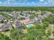Aerial view capturing a well-maintained community and a beautiful home with a private pool and patio at 7927 Hampton Lake Dr, Tampa, FL 33647