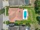 Aerial view shows the tile roof and backyard pool with manicured landscaping at 7927 Hampton Lake Dr, Tampa, FL 33647