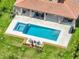Aerial view showcasing a pool, spa, covered patio, and well-maintained yard at 7927 Hampton Lake Dr, Tampa, FL 33647