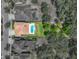 Aerial view showcasing a beautiful home with a private pool, nestled within lush green surroundings at 7927 Hampton Lake Dr, Tampa, FL 33647