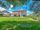Expansive backyard with a refreshing pool and ample green space, perfect for relaxation and recreation at 7927 Hampton Lake Dr, Tampa, FL 33647