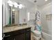 Bathroom featuring granite countertops, a white tiled shower, and playful shower curtain at 7927 Hampton Lake Dr, Tampa, FL 33647