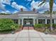 Grand Hampton clubhouse exterior featuring large windows, neutral paint, and elegant details at 7927 Hampton Lake Dr, Tampa, FL 33647