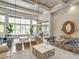 Grand Hampton clubhouse entry featuring coffered ceiling, elegant lighting, and comfortable seating at 7927 Hampton Lake Dr, Tampa, FL 33647