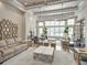 Grand Hampton clubhouse entry featuring coffered ceiling, elegant lighting, and comfortable seating at 7927 Hampton Lake Dr, Tampa, FL 33647