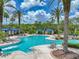 Grand Hampton community pool featuring a lagoon style pool, covered seating, and lush landscaping at 7927 Hampton Lake Dr, Tampa, FL 33647