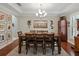 Formal dining room with wainscoting, a chandelier, and elegant decor is ready for entertaining at 7927 Hampton Lake Dr, Tampa, FL 33647