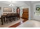 Open dining room with a large table, decorative chandelier, and built in wooden hutch at 7927 Hampton Lake Dr, Tampa, FL 33647