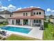Stunning exterior showcasing the pool, spa, covered patio, and manicured backyard at 7927 Hampton Lake Dr, Tampa, FL 33647