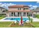 Spacious backyard features a pool, spa, covered patio, and lush landscaping at 7927 Hampton Lake Dr, Tampa, FL 33647