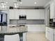 Open kitchen featuring granite island, stainless steel appliances, and modern pendant lighting at 7927 Hampton Lake Dr, Tampa, FL 33647