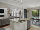 Modern kitchen island with granite countertop, stainless steel appliances, and open layout to living area at 7927 Hampton Lake Dr, Tampa, FL 33647