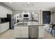 Bright kitchen with granite island, stainless steel appliances, white cabinets, and open concept design at 7927 Hampton Lake Dr, Tampa, FL 33647