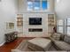 Sun-drenched living room featuring high ceilings and a stone fireplace at 7927 Hampton Lake Dr, Tampa, FL 33647