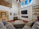 Bright living room featuring high ceilings, a stone fireplace, and large windows at 7927 Hampton Lake Dr, Tampa, FL 33647