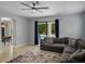 Inviting living room with a comfortable gray sofa, natural light, and easy access to the outdoor pool area at 7927 Hampton Lake Dr, Tampa, FL 33647